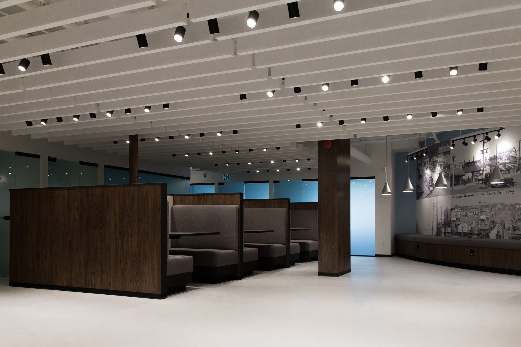West Quay commercial tenant improvement — blade baffle ceiling and walnut booths, North Vancouver